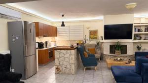 a kitchen and a living room with a refrigerator at Babis House in Pelekas