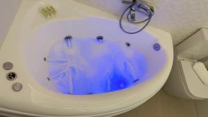 a white bath tub with a blue substance in it at Babis House in Pelekas +36 photos