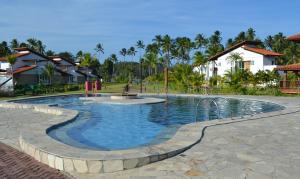 a pool at a resort with a playground at Flat Praia dos Carneiros in Praia dos Carneiros