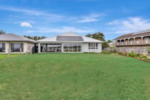 an image of a house with a large yard at Tilligerry Beach Retreat in Taylors Beach