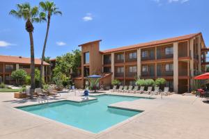 a swimming pool in front of a building with a hotel at 3 Palms Tucson North Foothills in Tucson