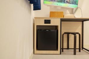 a kitchen with a counter with a dishwasher and a table at 미니호텔 먹 in Seoul