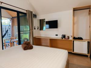 a bedroom with a bed with a teddy bear on it at Pai Nam Now in Pai