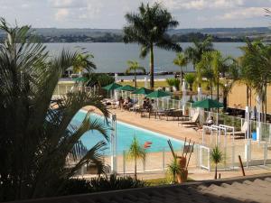 a view of a swimming pool with tables and umbrellas at Life Resort in Brasília