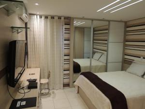 a bedroom with a bed and a television in a room at Life Resort in Brasília