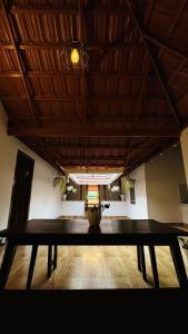a wooden table in a room with a ceiling at Aadhya Homestay 4BHK in Wayanad