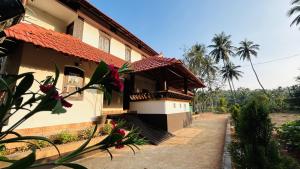 a building with a staircase next to a house at Aadhya Homestay 4BHK in Wayanad