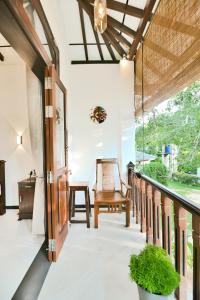 an open hallway with a chair and a window at Mansion view - Rose Patals in Unawatuna