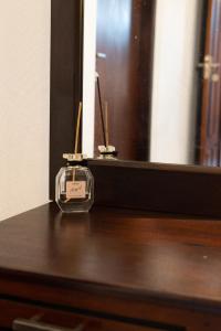 a clock sitting on top of a wooden dresser at Mansion view - Rose Patals in Unawatuna