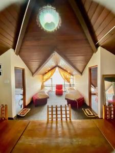 a room with two beds and a wooden ceiling at Hill Paradise Nuwaraeliya in Nuwara Eliya +29 photos