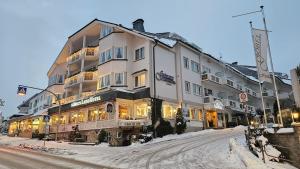 a large building on the side of a snowy street at Göbels Landhotel in Willingen