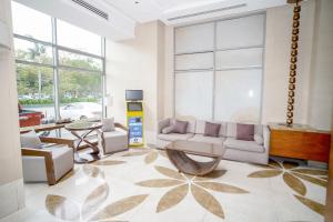 a living room with a couch and a table at Eton Baypark Manila Bay in Manila