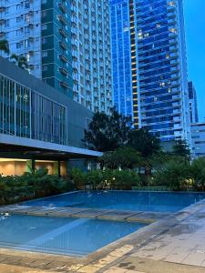 a swimming pool in a city with tall buildings at Riala Suite Cebu in Sampong