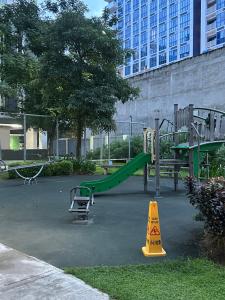 a park with a playground with a slide and arolley at Riala Suite Cebu in Sampong
