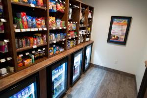 a grocery store with three televisions in a room at My Place Hotel - Atlanta West I-20/Lithia Springs, GA in Lithia Springs