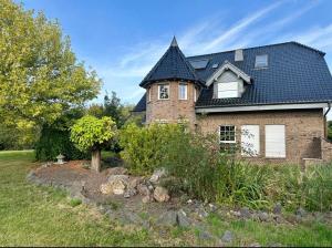a large brick house with a black roof at Aparthotel Casa Vasco - by Willms & Schömer eG in Euskirchen