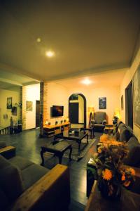 a large living room with couches and a tv at Sardar Villa NathiGalli in Bāzār