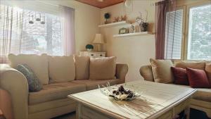 a living room with a couch and a table at Peaceful house for relaxing in Oulu