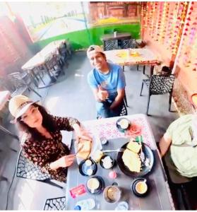 a man and a woman standing next to a table with food at The Taj Homes in Agra