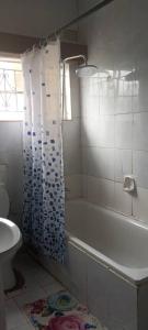 a bathroom with a tub and a toilet and a sink at MATT Bed and Breakfast in Lilongwe +24 photos