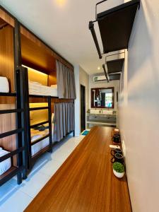 a room with bunk beds and a wooden floor at Wish Uluwatu in Uluwatu