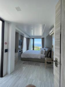 a bedroom with a bed and a view of the ocean at The Blue Lion Villa Samui in Chaweng Noi Beach +41 photos