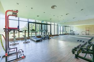 a gym with several treadmills and a swimming pool at Hallasan Resort in Sanch'ŏndan