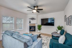 a living room with two blue couches and a ceiling fan at Stunning Home near Universal Kids Resort, Frisco in Little Elm