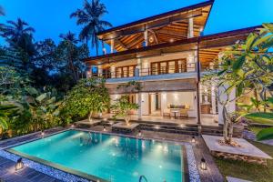 a house with a swimming pool in front of it at OMA Hikkaduwa in Hikkaduwa