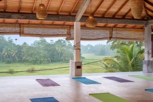 a yoga room with a view of a field at OMA Hikkaduwa in Hikkaduwa