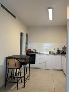 a kitchen with a table and chairs in a room at Shemesh Boutique in Beit Shemesh