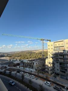 a view of a city with a crane at Shemesh Boutique in Beit Shemesh