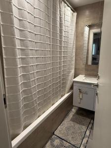 a bathroom with a shower curtain and a sink at Shemesh Boutique in Beit Shemesh
