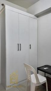 a white room with a white chair and a table at Sophisticated 1BR Unit w Panoramic Horizon View in Cebu City +18 photos