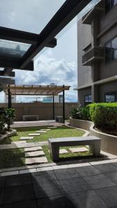 a patio with a bench in front of a building at Sophisticated 1BR Unit w Panoramic Horizon View in Cebu City