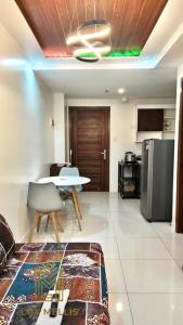 a living room with a table and a kitchen at Sophisticated 1BR Unit w Panoramic Horizon View in Cebu City