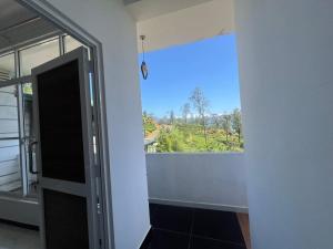 a room with a window and a door with a view at Adams Peak Lake Resort in Nallathanniya +44 photos