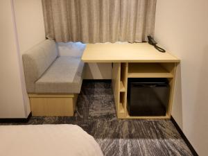 a small room with a desk and a bed at Via Inn Prime Kumamoto in Kumamoto +16 photos