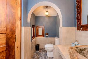 a bathroom with a toilet and a sink at OMA Hikkaduwa in Hikkaduwa +28 photos