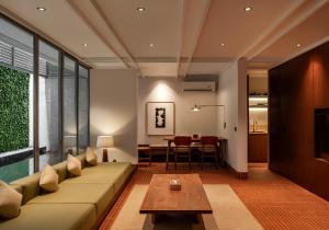 a living room with a couch and a table at Brown Feather Pererenan in Canggu