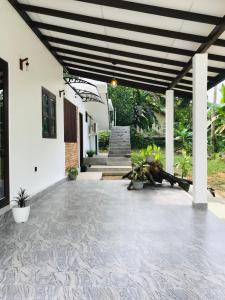 a patio of a house with awning at The Vinza in Hikkaduwa