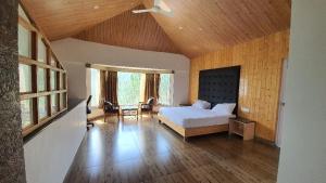a bedroom with a bed and a wooden ceiling at Blue Pine Orchards in Lansdowne +71 photos