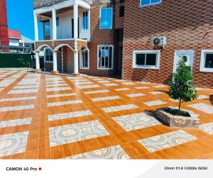 a building with a courtyard with a tree on it at kimkeri hotel in Ogbojo