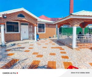 a brick house with a stone patio in front of it at kimkeri hotel in Ogbojo