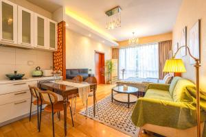 a living room with a couch and a table at Anju Apartment in Beijing