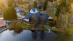 an aerial view of a large house on the water at Penzion Koucký in Bedřichov