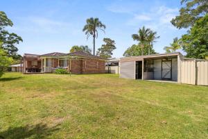 a house with a lawn in front of it at Casa LuCe by Experience Jervis Bay in Erowal Bay