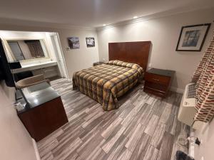 a hotel room with a bed and a desk at Crescent Motel, South Gate - Los Angeles in South Gate