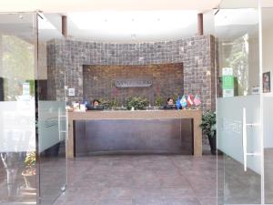 a lobby with a stone wall and a counter at San Gregorio Hotel & SPA in Villa Canales