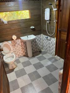 a bathroom with a toilet and a sink at Namnoncave Resort in Ban Namnon
